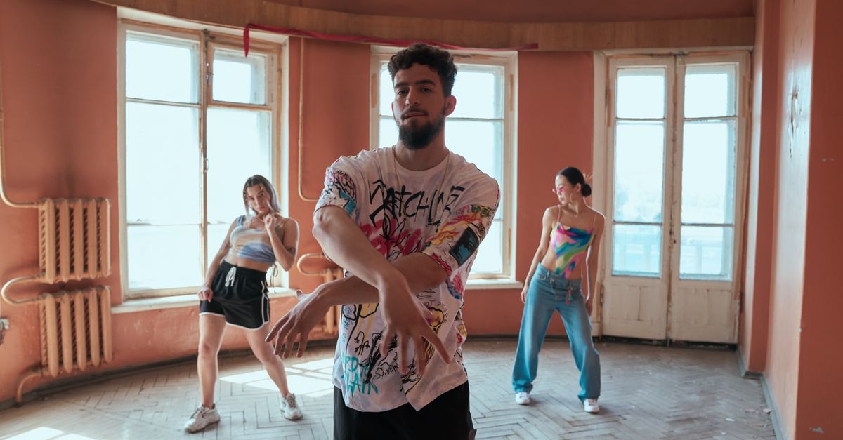 Three diverse dancers showcase hip-hop moves in a vintage styled room, exuding energy and creativity.